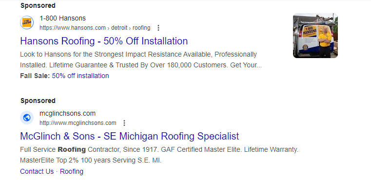 A screenshot showing two search campaign results for the query "roofing company." The first ad says "Hansons Roofing- 50% Off Installation" and the second ad says "McGlinch & Sons-SE Michigan Roofing Specialist"